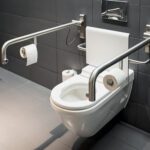 Close up image of a toilet with an iron rod